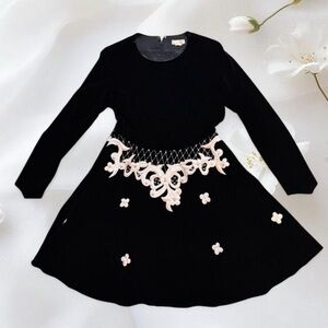 Vintage black velvet dress with white lace and floral embellishments